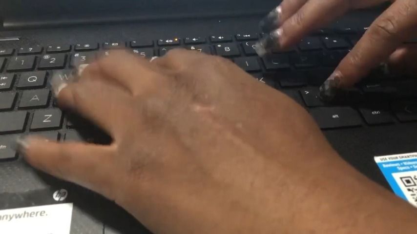 Sexy nails tapping on laptop keys