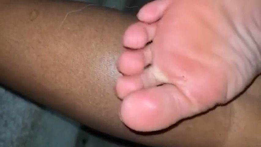 rubbing soles on legs