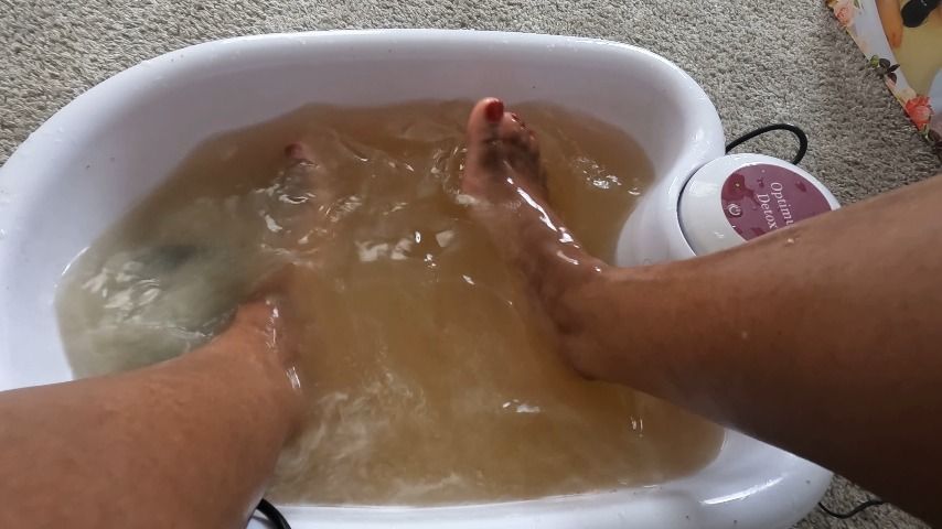 Soles splashing in foot bath