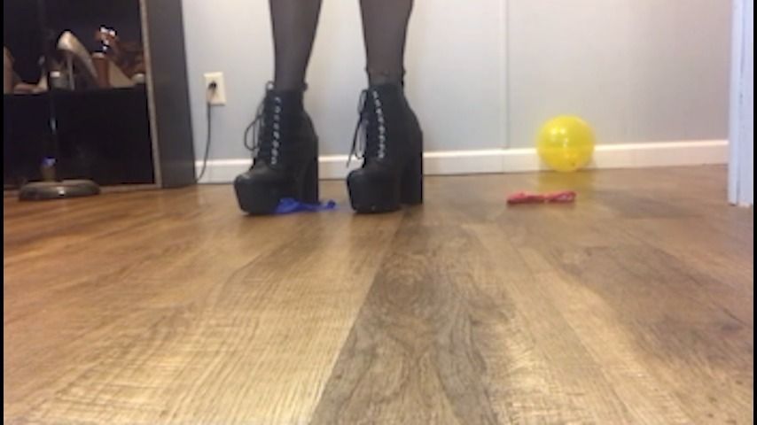 Stomping balloons in black heeled boots