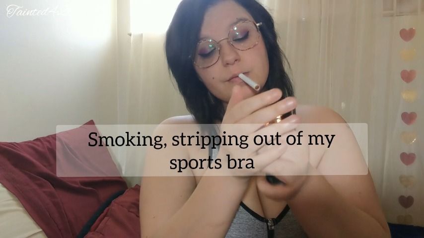 Smoking, stripping in sports bra