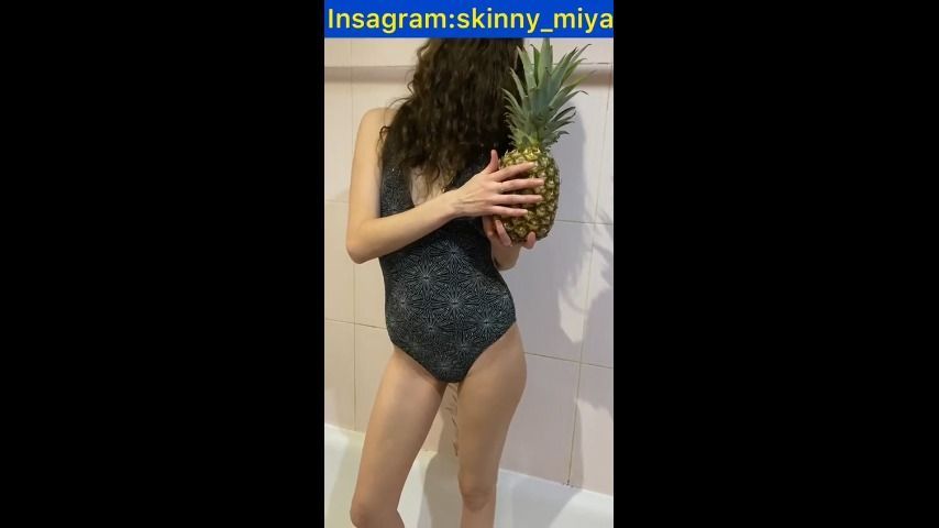 skinny girl playing with pineapple