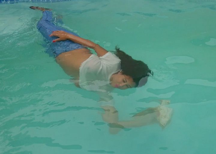 Peril in the pool in jeans, white shirt and zebra panties