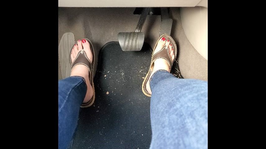 Red Toenails Driving in Sandals