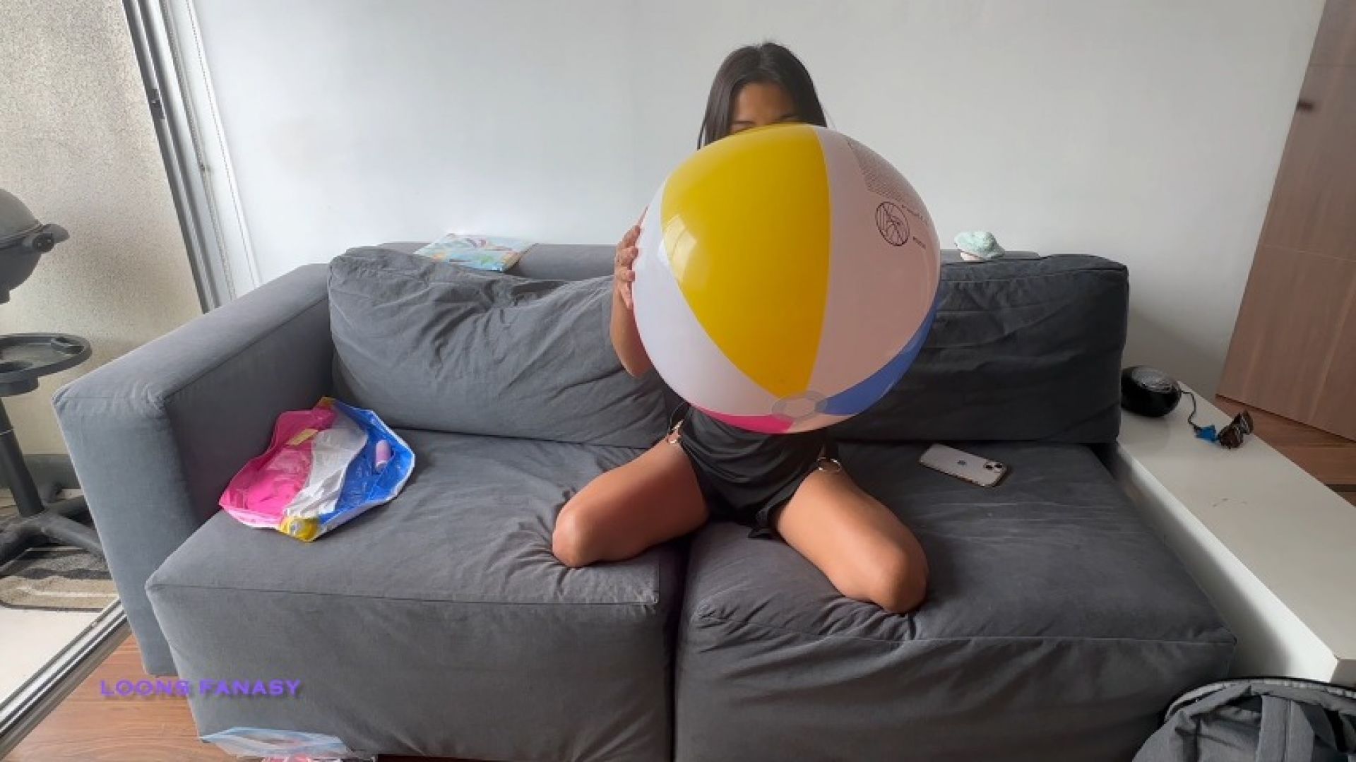 Akina blows and pops beach ball