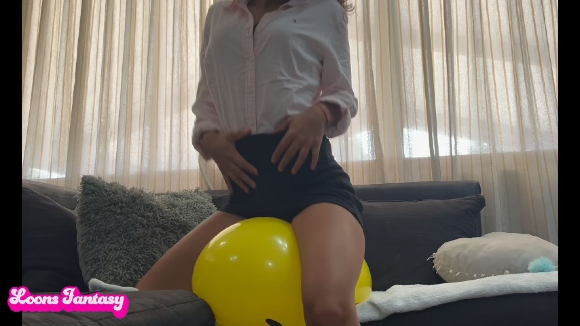 Secretary Akina plays and pops her smiley balloon