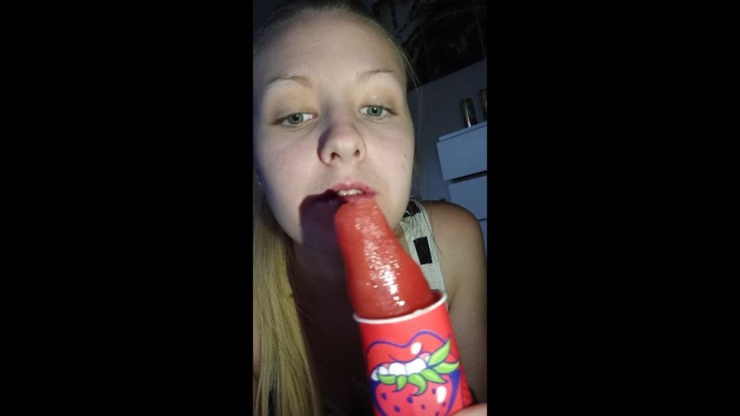 Sweet blonde is licking a popsicle