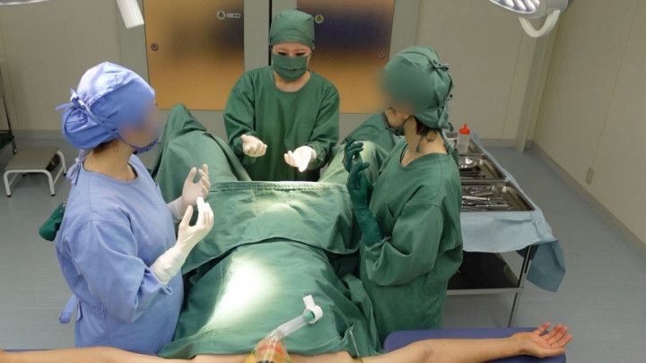 Asians in surgical gowns