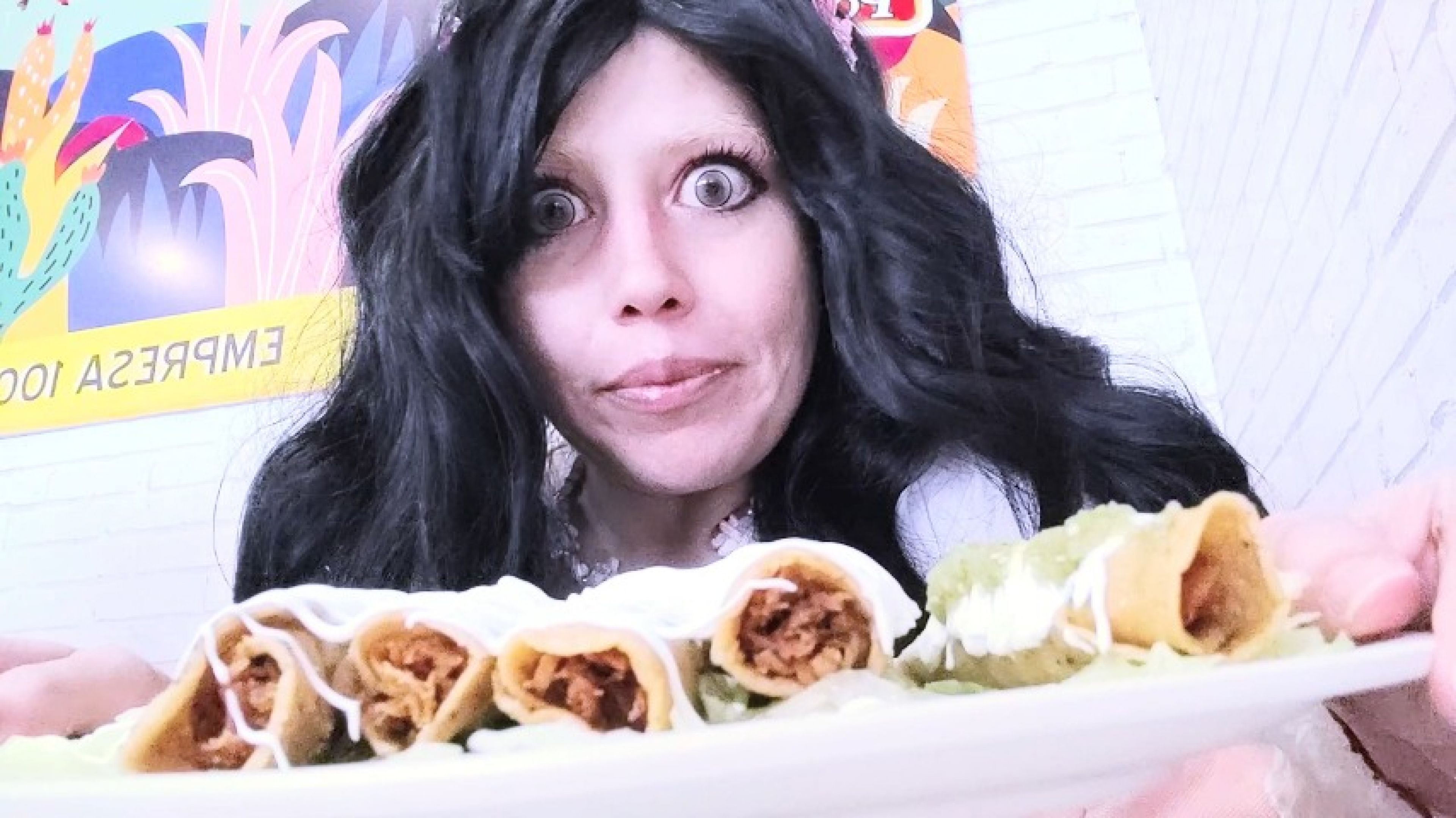 black hair eating fried taco