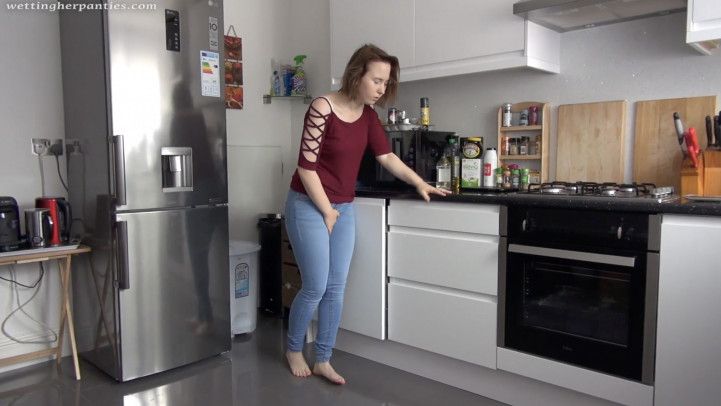 Monika wets her jeans in the kitchen