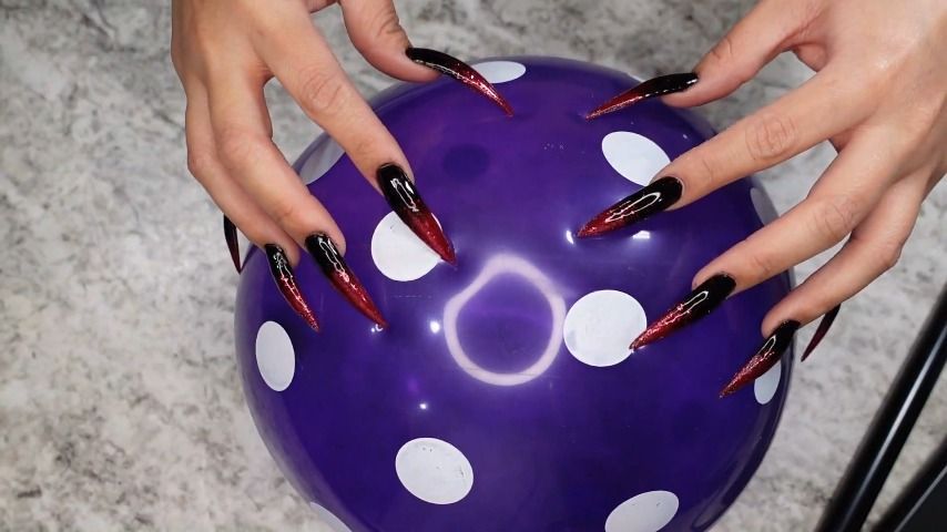 Long Nail Talons Scratching a Balloon