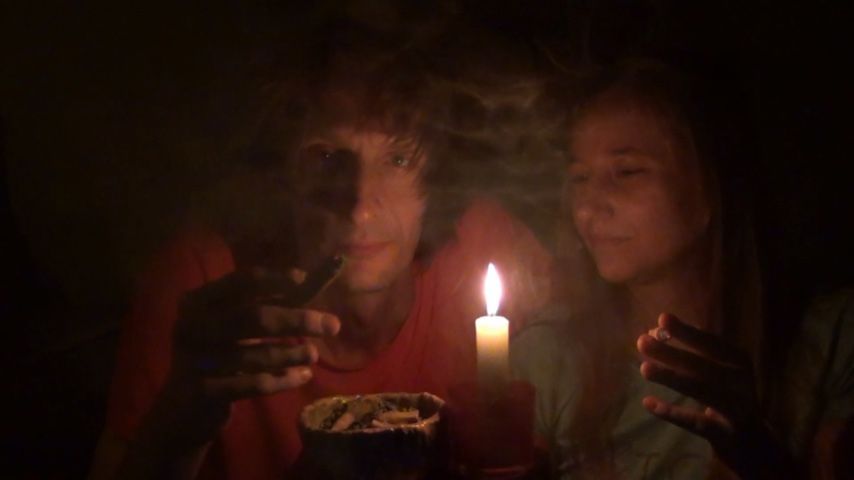 Couple smoking next to candle