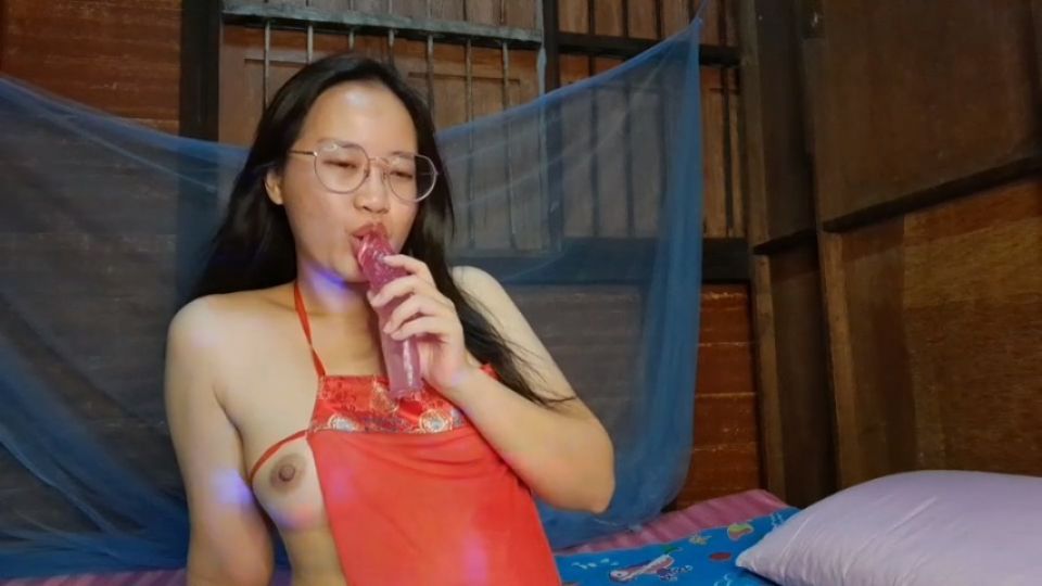 Cute Asian girl in her room lick dildo