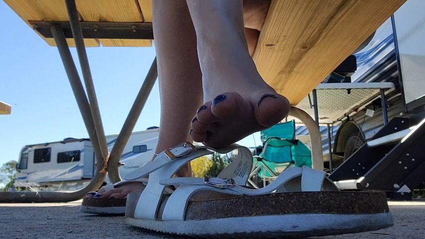 Dirty feet in sandals while camping