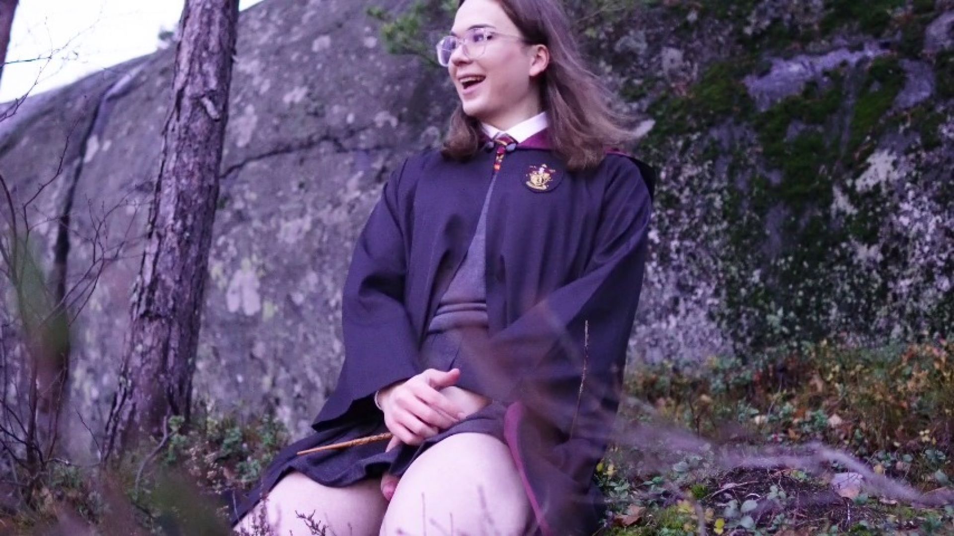 A witch touches her magic wand in the Forbidden Forest