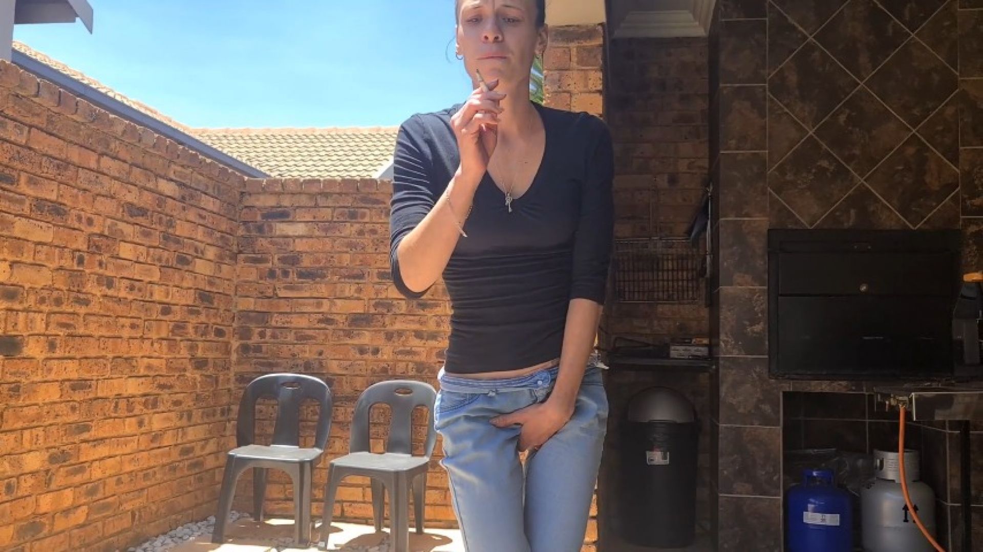 Petite girl piss desperation in jeans. Smoking cigarette