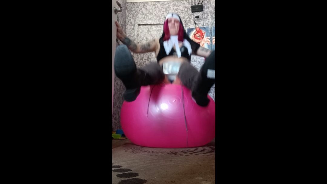 Nun jumping on pink ball