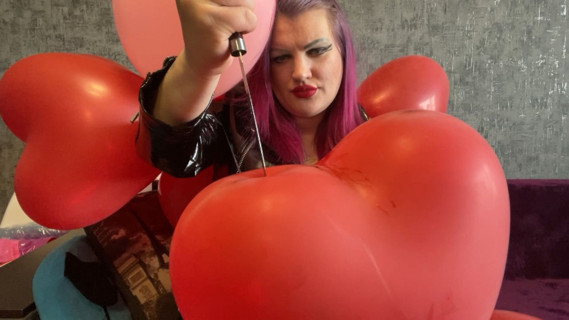 Girl in latex pop heart balloons