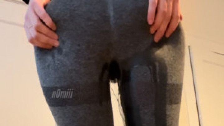 pissing in tight gray leggings