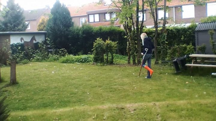 Walking Through The Garden With Crutches And Smoking