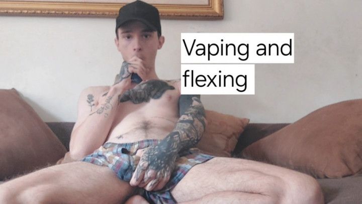 Tatted guy flexing and vaping in boxers