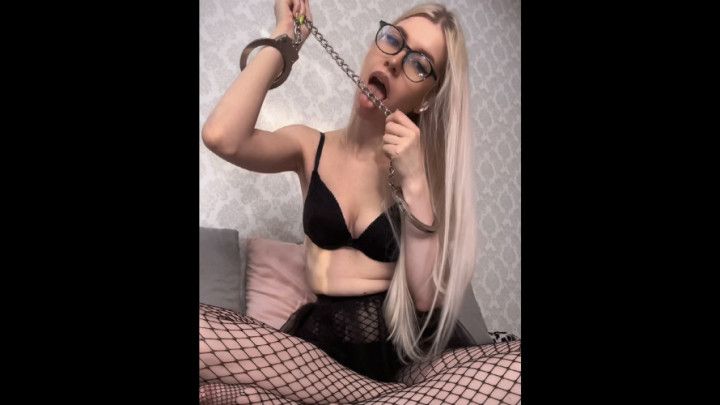 Licking handcuffs in fishnet and glasses