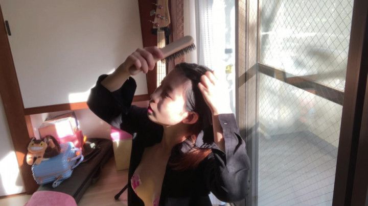 mako, combing her hair by the window