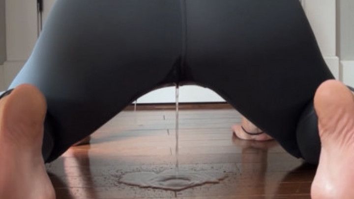 Peeing in gray yoga pants on hardwood