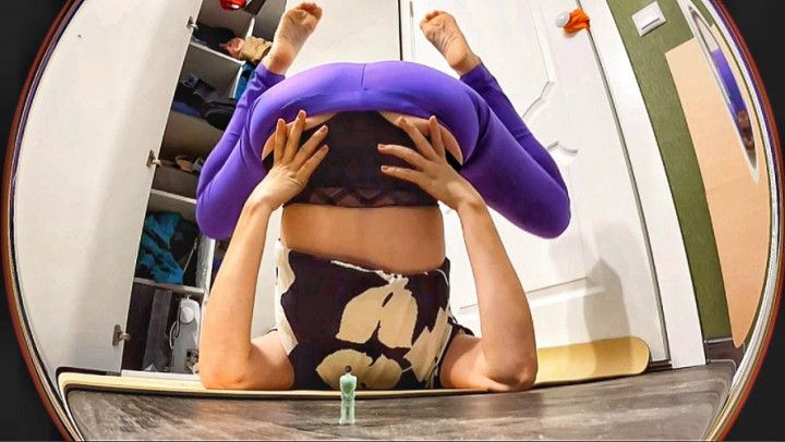 Unaware giantess in dropped leggings is practicing yoga