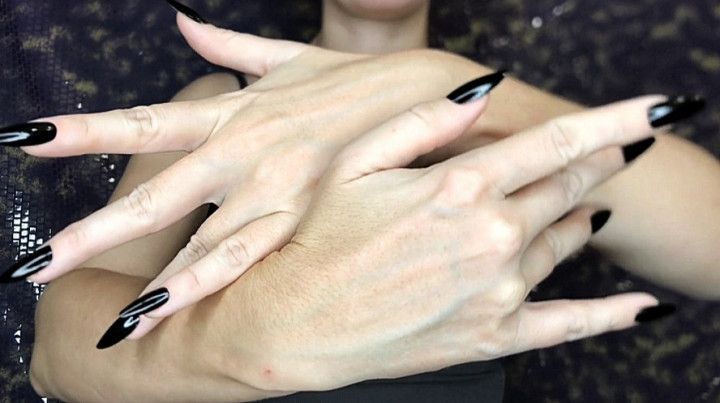 Graceful hands with long black nails