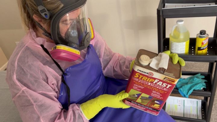 Respirator Masked and Gloved Milf Reads Warning Labels