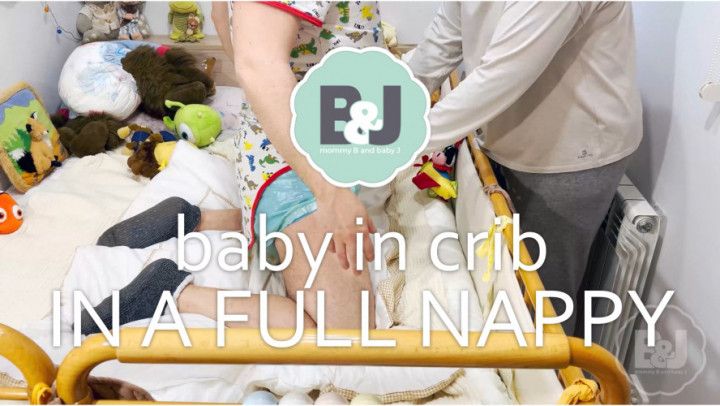 Baby in crib in a full nappy