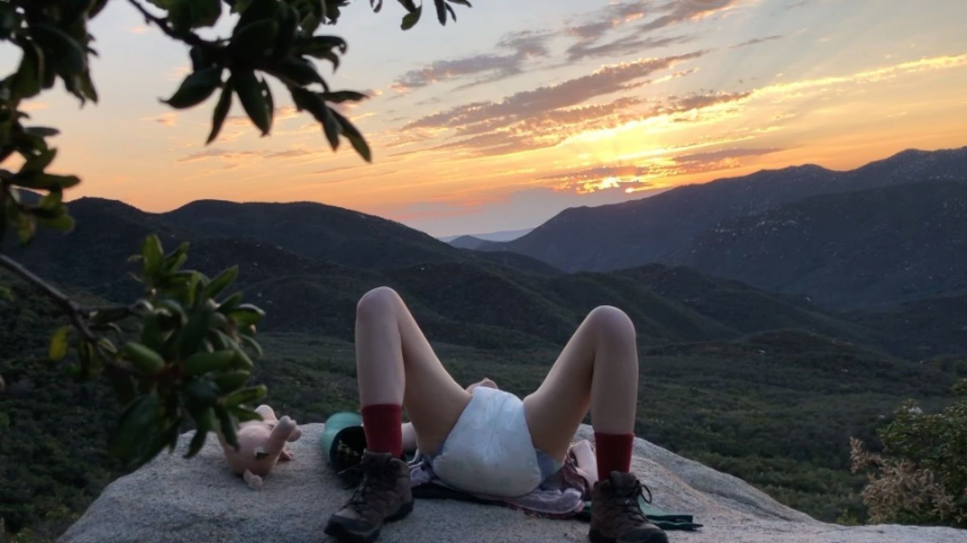 Diaper girl posing outdoors with sunset