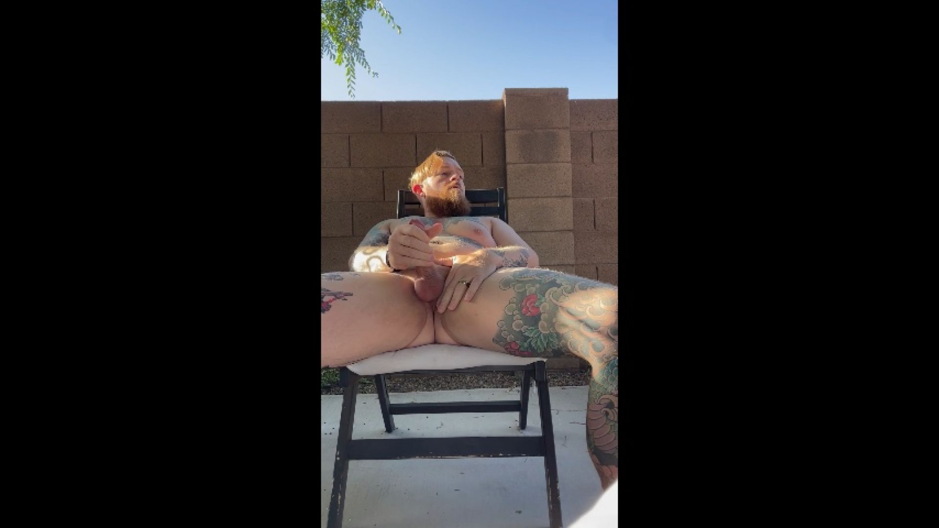 Tattooed DILF jerks off naked outside