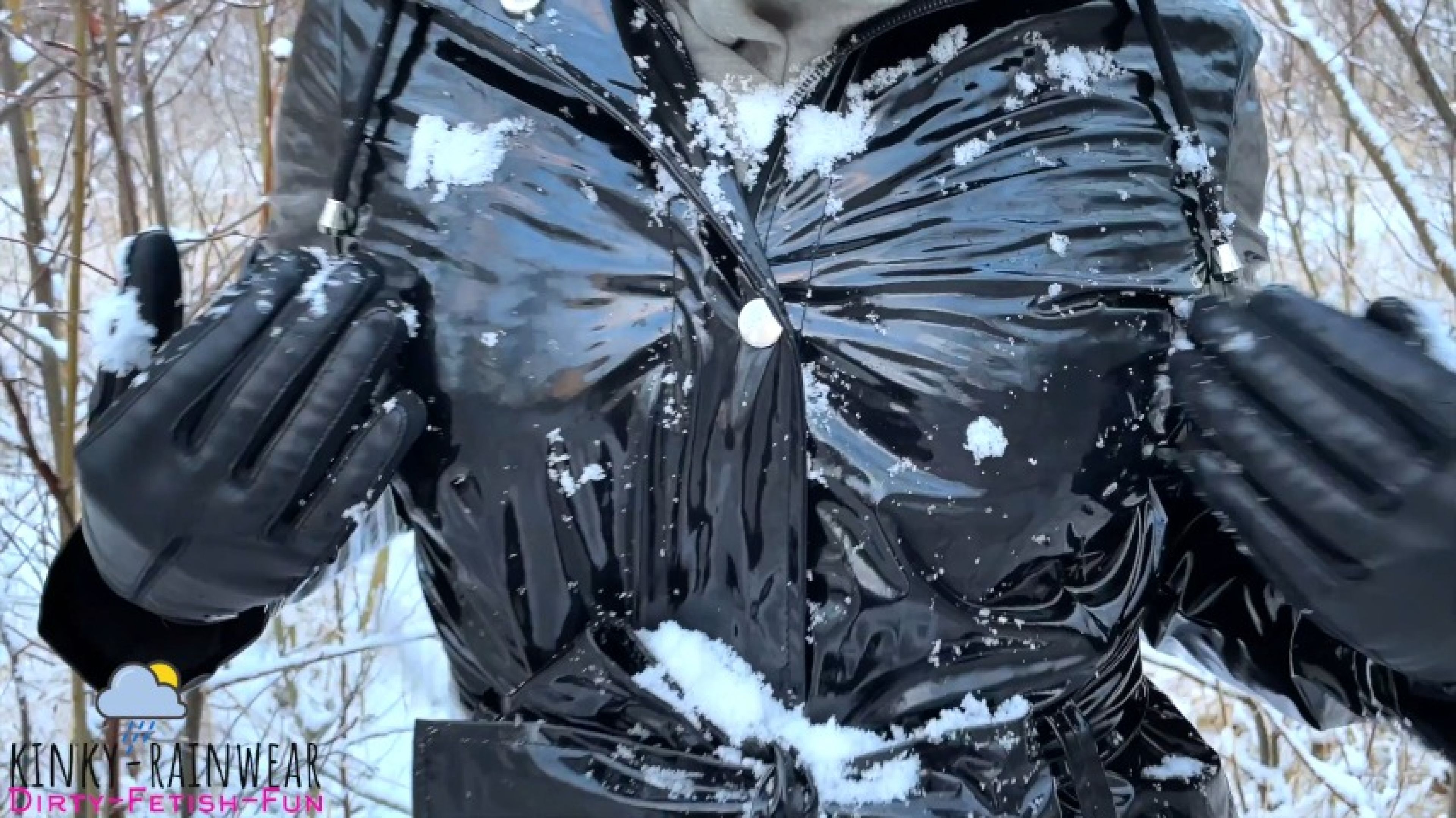 cute girl in shinny black latex raincoat playing with snow