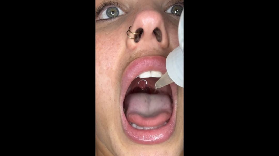 Sammie swallows water with mouth open while laying down