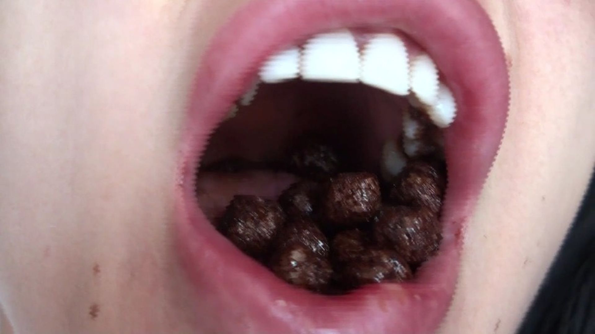 Lucy grinds chocolate balls with her teeth