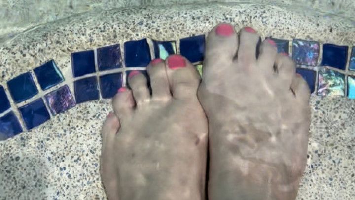 Pretty feet playing in the water