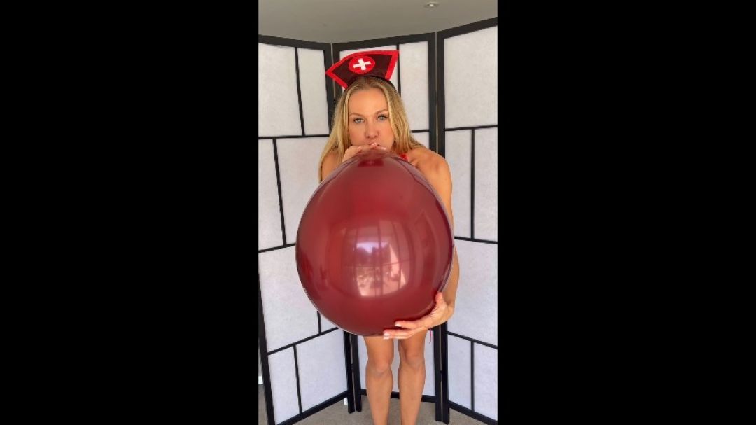 inflating a balloon in a nurse latex costume non pop