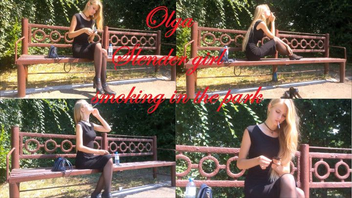 Slender girl Olga smoking in the park