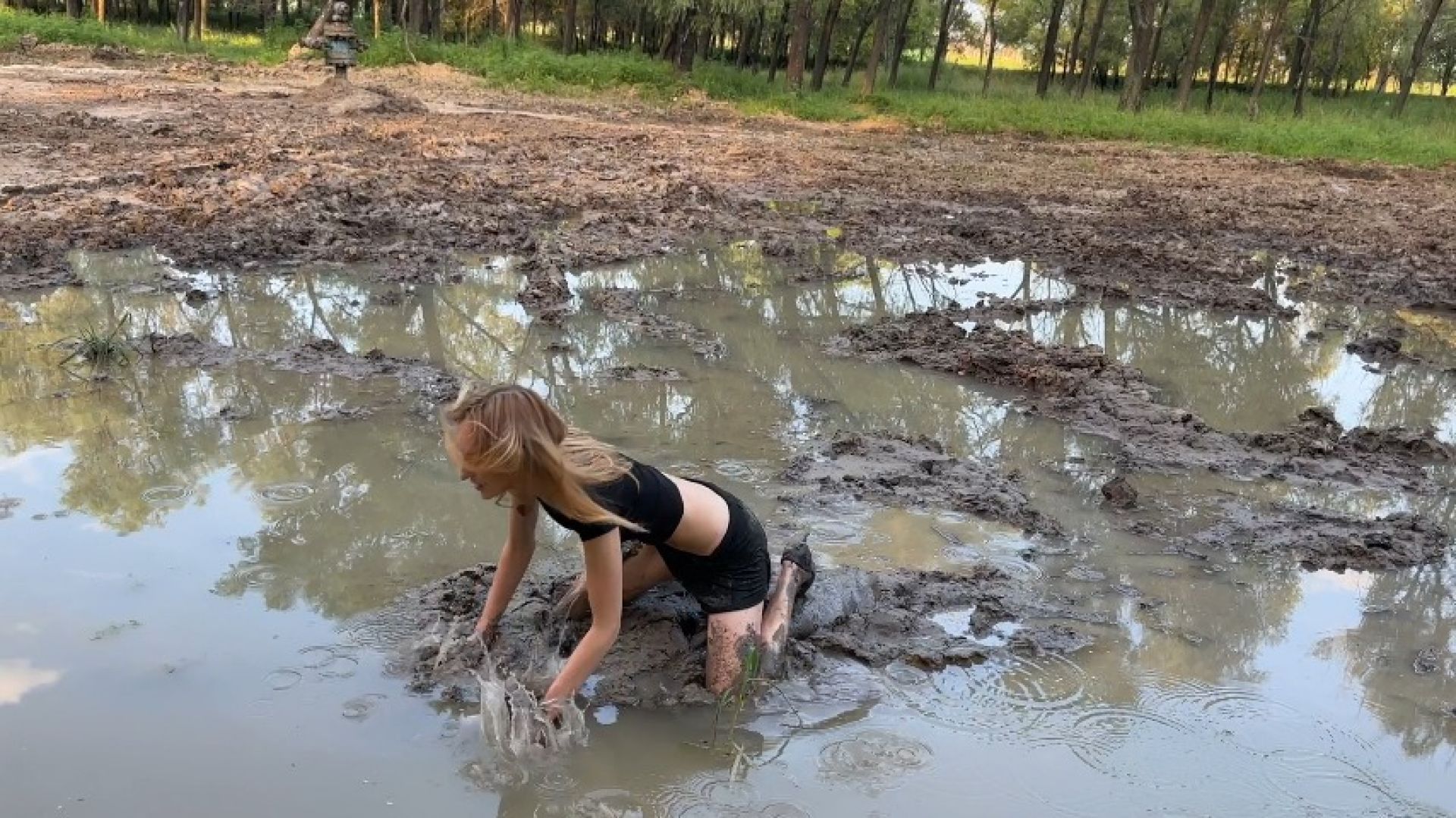 girl walk through mud, got her shoes stuck and fell in mud