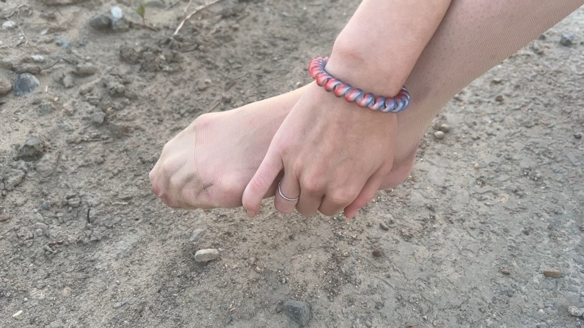 girl walking along road in ballet shoes and twisted her leg