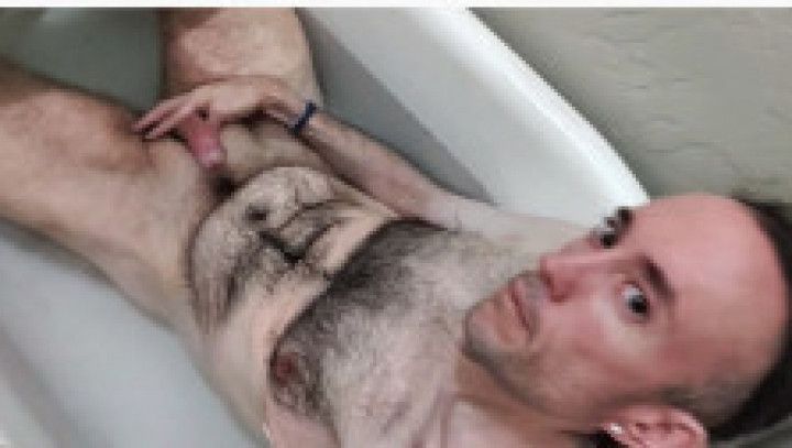 Me, fully nude, in the bathtub, playing with my small cock