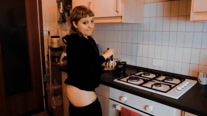 Lovely young wife makes hot coffee with buttrack