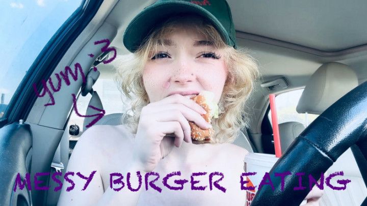 petite girl with braces scarfs down hamburger