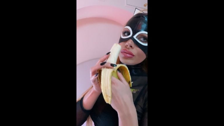 Catwoman is licking her banana