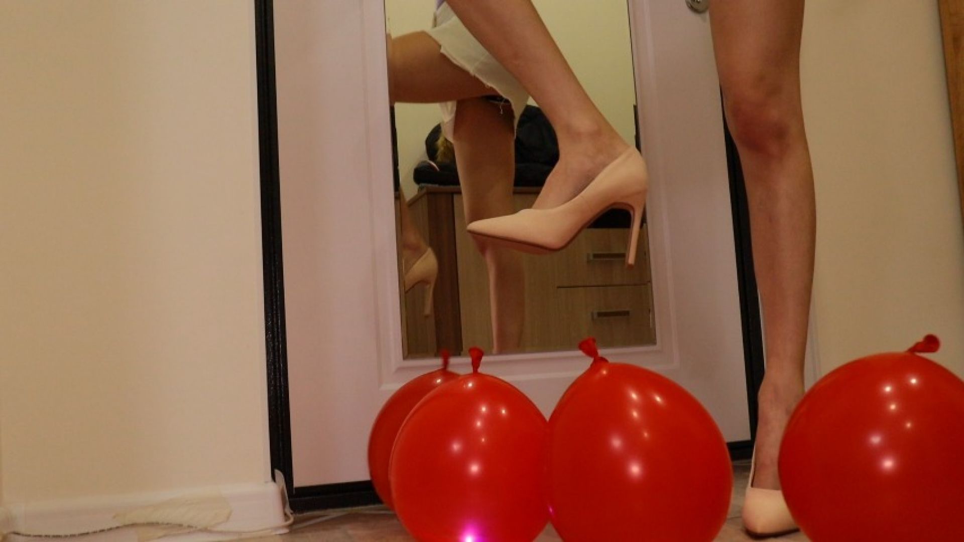 Heels crush balloons. Crushing heels