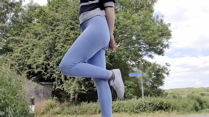 Blue leggings wetting by the road peeing