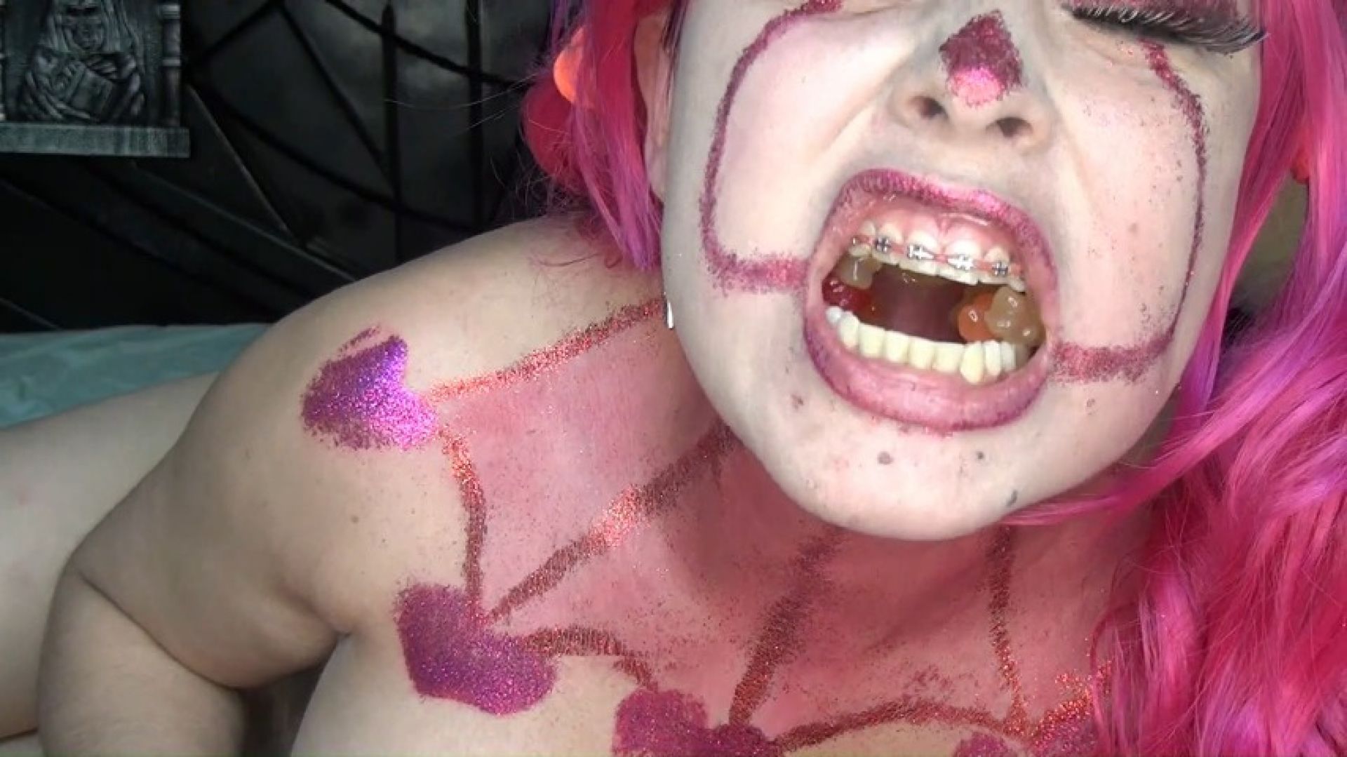 Evil sexy clown swallows hundreds of gummy bears