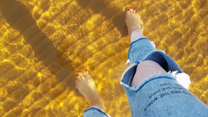 POV feet modeling on the beach